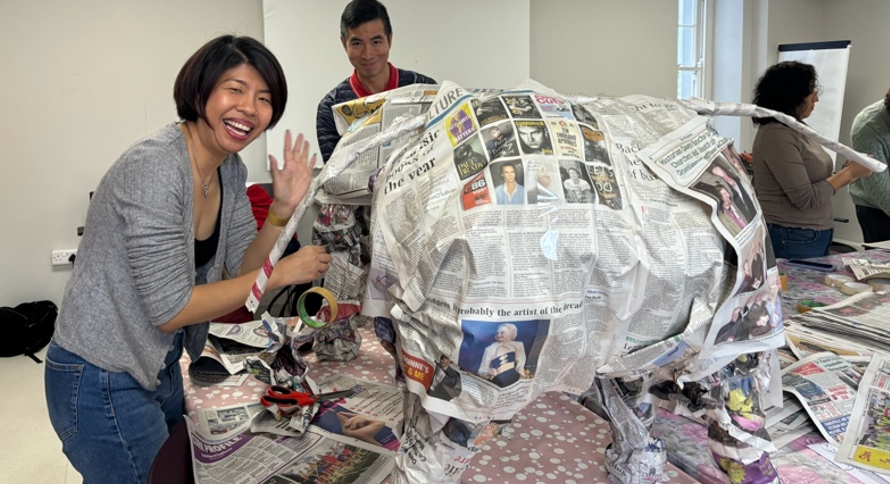 Making an elephant with newspaper and waving