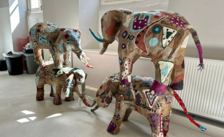 four paper elephants in a room